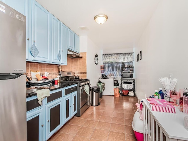 kitchen with blue cabinetry, decorative backsplash, light tile patterned floors, and stainless steel appliances