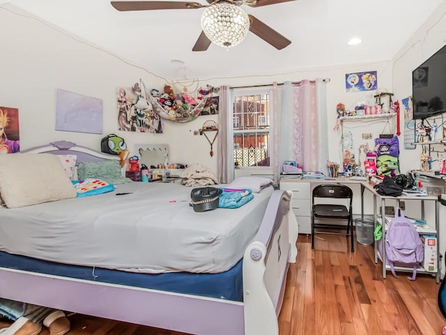 bedroom with ceiling fan and light hardwood / wood-style floors