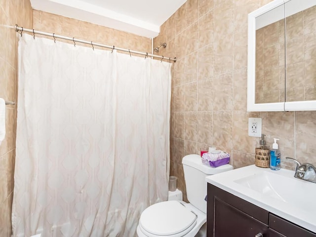 bathroom with a shower with shower curtain, vanity, toilet, and tile walls