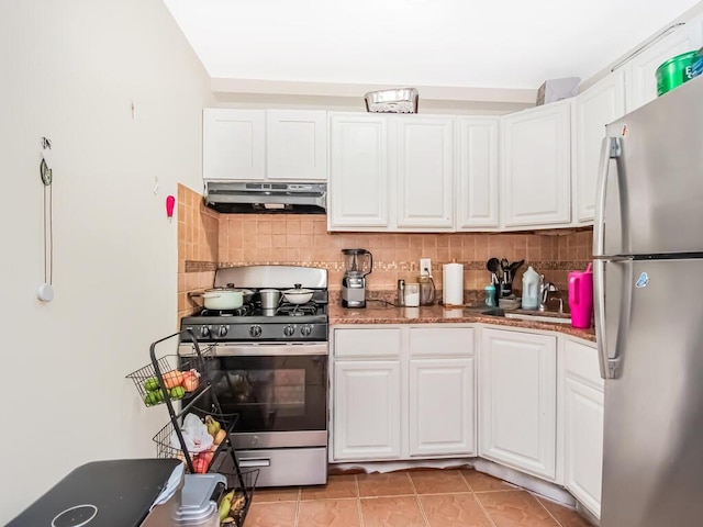 kitchen with white cabinets, stainless steel appliances, and tasteful backsplash