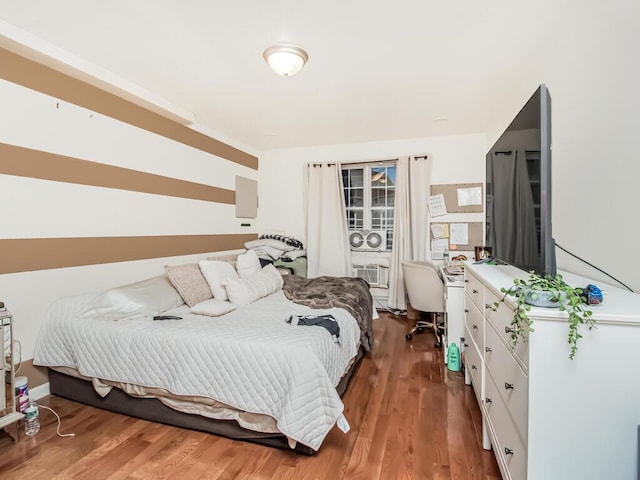 bedroom with dark wood-type flooring