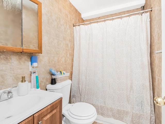 bathroom with a shower with shower curtain, vanity, toilet, and tile walls