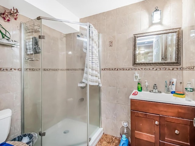 bathroom with walk in shower, tasteful backsplash, toilet, vanity, and tile walls