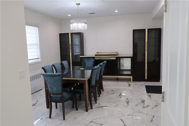 dining room featuring radiator heating unit and a notable chandelier