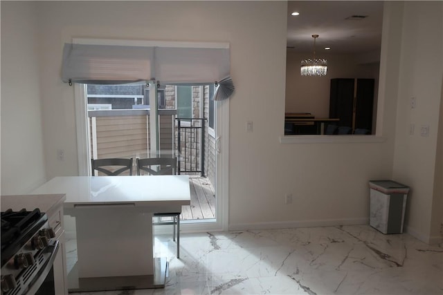 kitchen with a kitchen breakfast bar, black range with electric stovetop, hanging light fixtures, and a chandelier