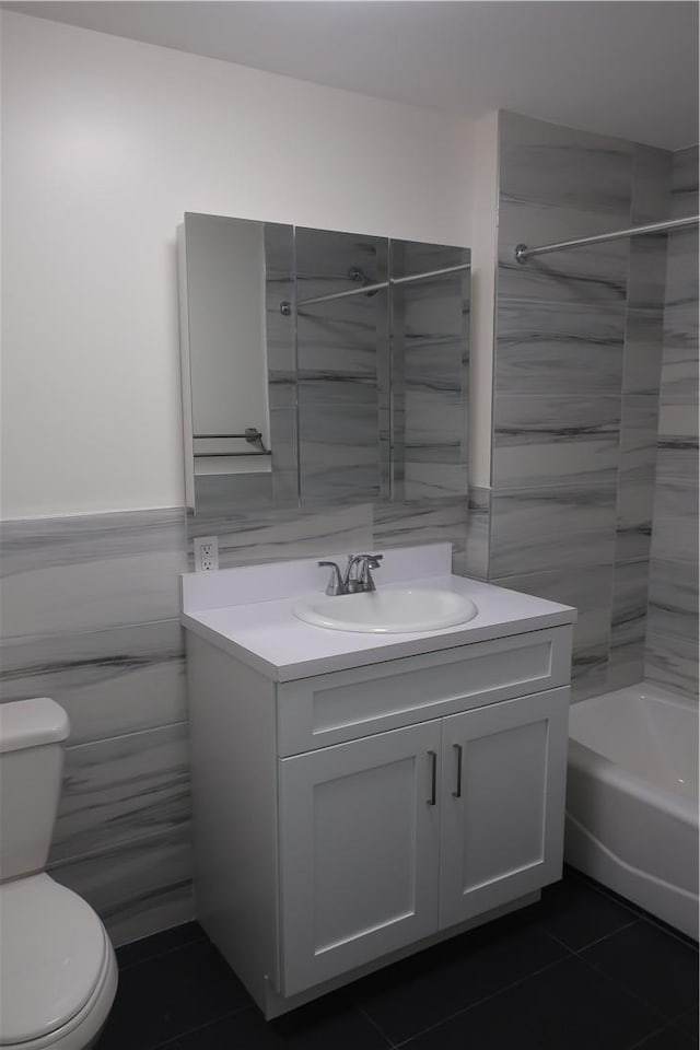 bathroom with toilet and tile walls