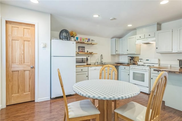 kitchen featuring white cabinetry, wood-type flooring, white appliances, and sink