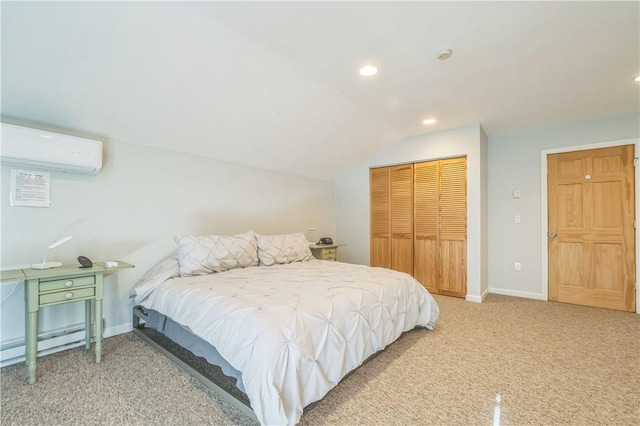 bedroom with a wall mounted air conditioner, a baseboard heating unit, lofted ceiling, a closet, and carpet