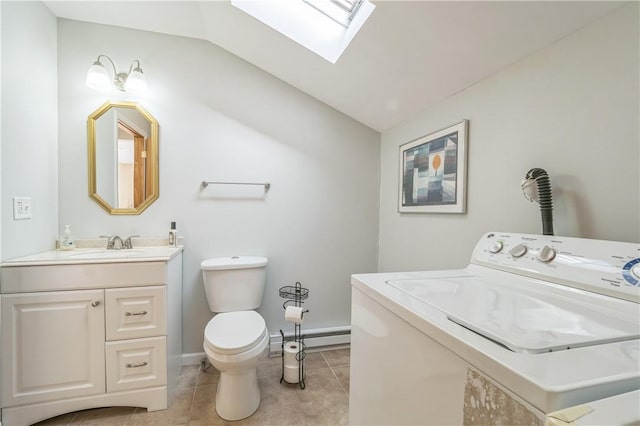 bathroom featuring vaulted ceiling with skylight, tile patterned flooring, a baseboard heating unit, and washer / dryer