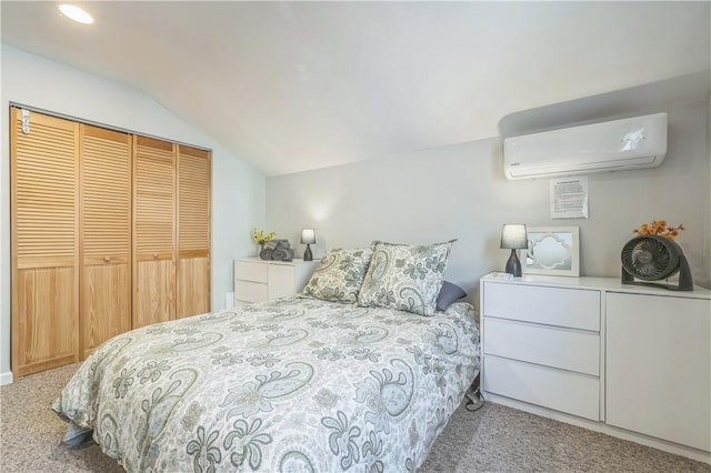 bedroom featuring a wall mounted air conditioner, light colored carpet, lofted ceiling, and a closet