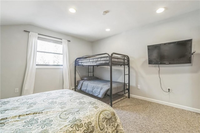 carpeted bedroom with lofted ceiling