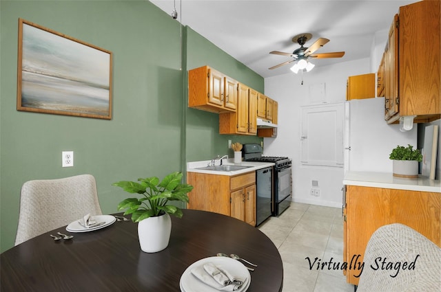 kitchen with black appliances, ceiling fan, light tile patterned floors, and sink