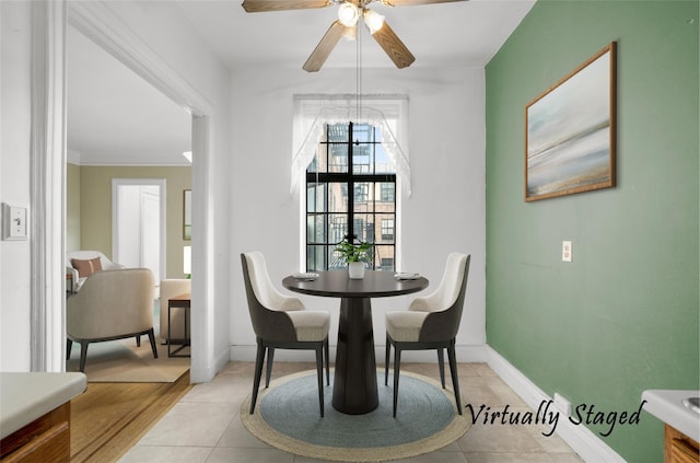 dining area with ceiling fan, light hardwood / wood-style flooring, and ornamental molding