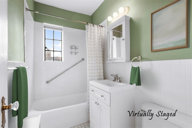 full bathroom featuring tile patterned flooring, shower / bath combination with curtain, toilet, vanity, and tile walls