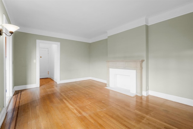 spare room featuring ornamental molding and light hardwood / wood-style flooring