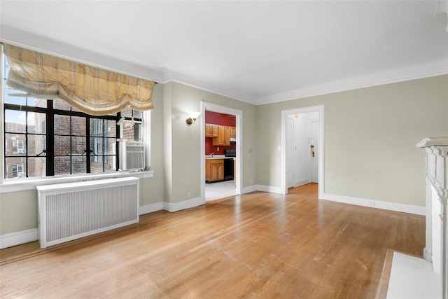 interior space with radiator heating unit, light wood-type flooring, cooling unit, and crown molding