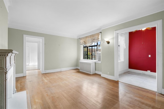 interior space featuring radiator heating unit, light wood-type flooring, and crown molding