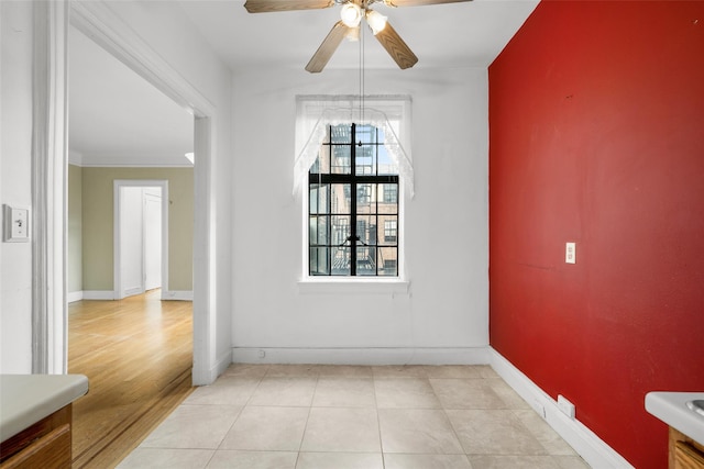 unfurnished room featuring light hardwood / wood-style flooring, ceiling fan, and ornamental molding