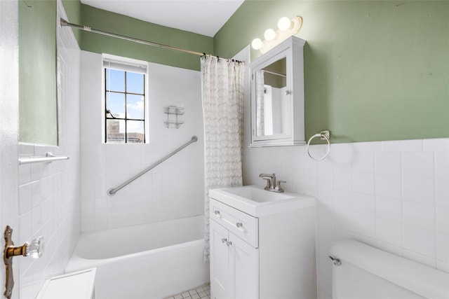 full bathroom with vanity, tile patterned floors, toilet, shower / bath combo with shower curtain, and tile walls