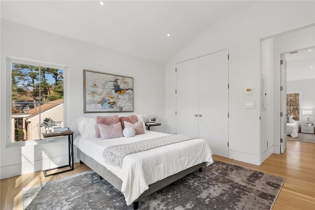 bedroom featuring wood-type flooring and lofted ceiling