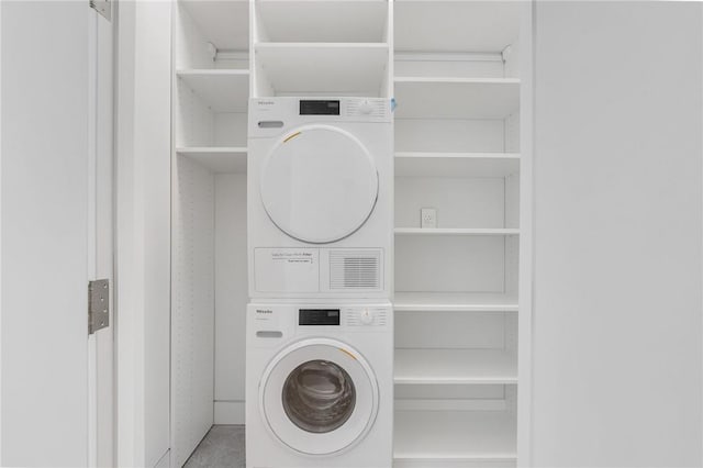 laundry room with stacked washer / drying machine