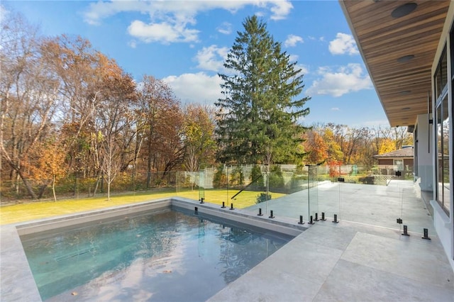 view of swimming pool with a yard and a patio area