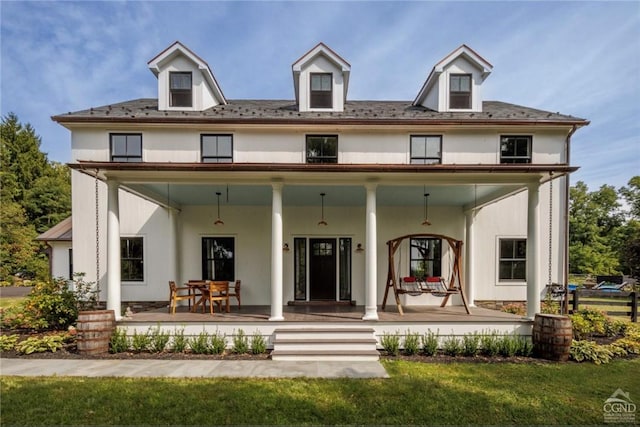 view of front facade featuring covered porch and a front yard