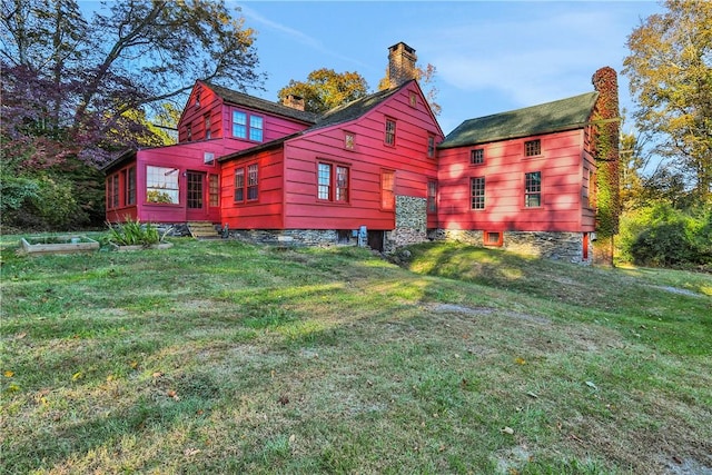 rear view of house with a yard