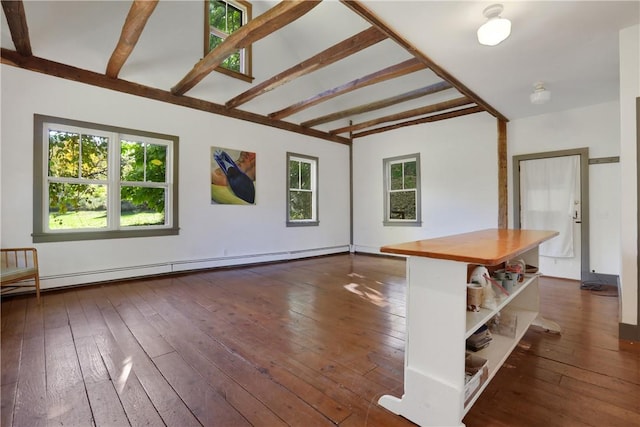 unfurnished living room featuring beam ceiling, dark hardwood / wood-style flooring, a wealth of natural light, and a baseboard heating unit