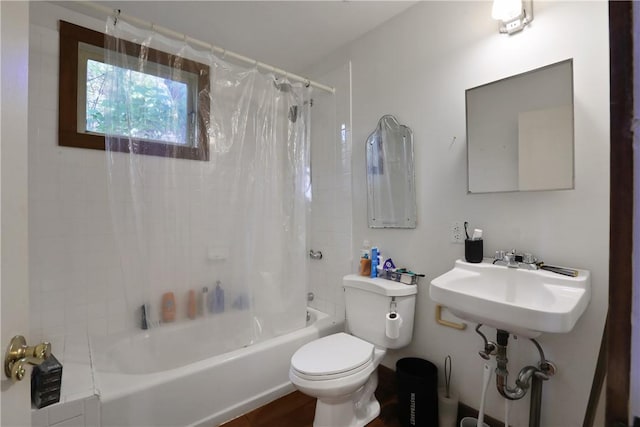 full bathroom featuring toilet, shower / bath combo with shower curtain, and sink