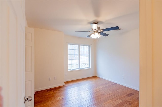 empty room featuring ceiling fan and light wood-type flooring