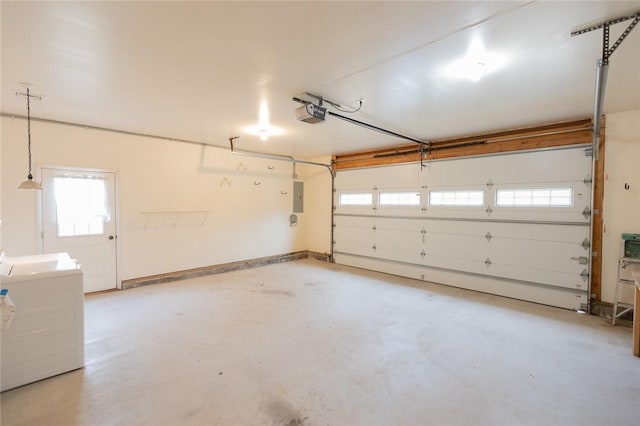 garage featuring electric panel, washer / clothes dryer, and a garage door opener