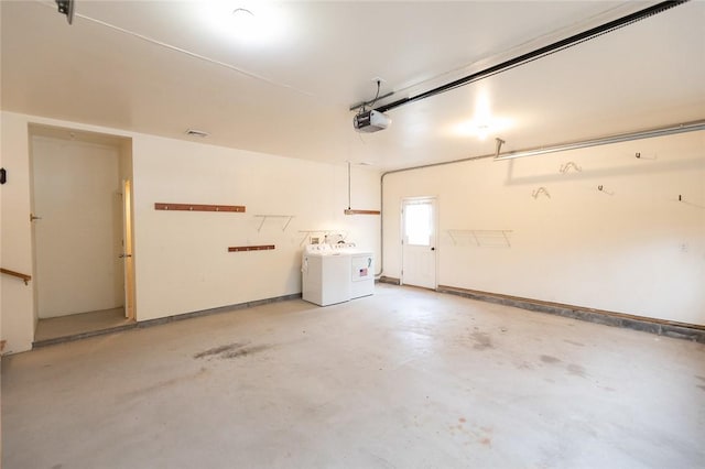 garage featuring washing machine and dryer and a garage door opener