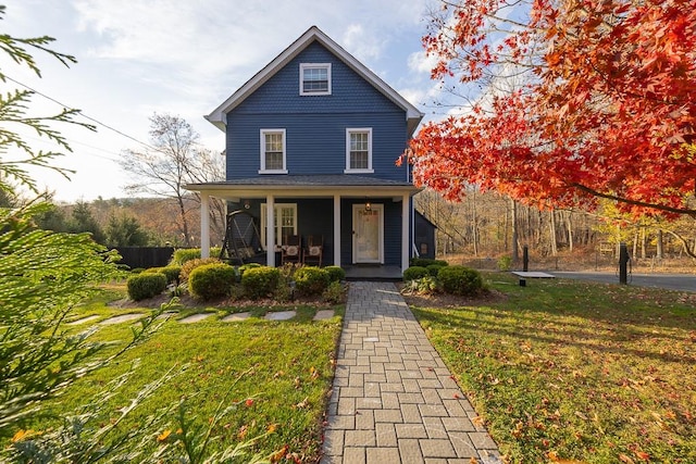 view of front of home with a porch and a front yard