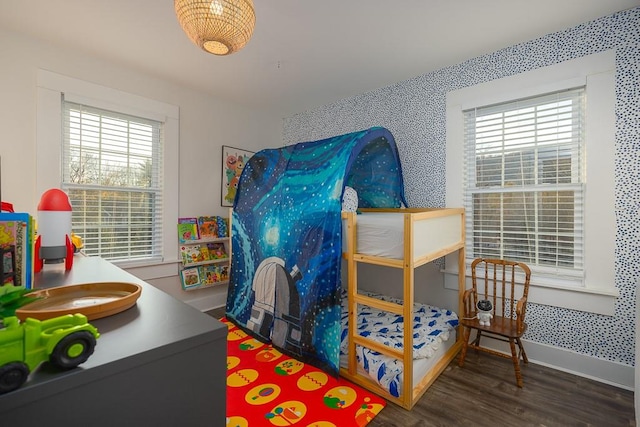 bedroom with dark wood-type flooring and multiple windows