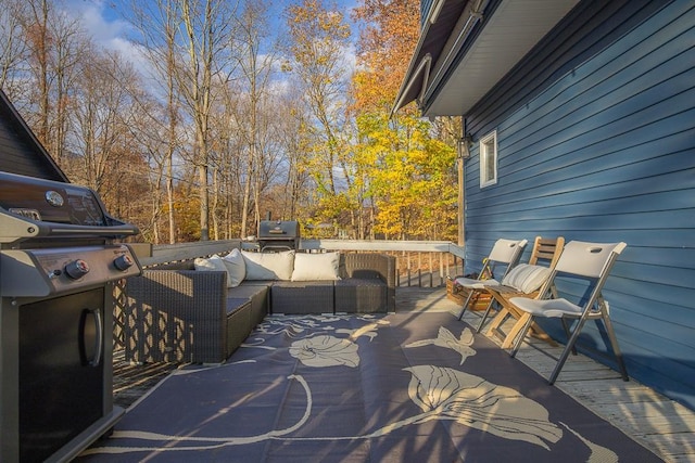 wooden terrace featuring an outdoor hangout area and grilling area