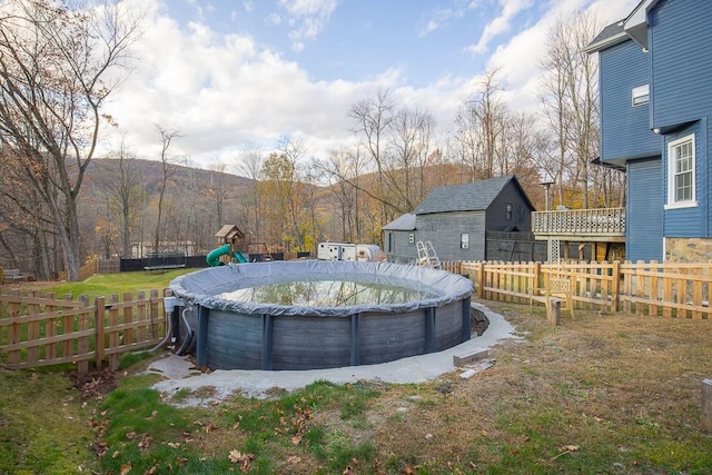 view of yard with a mountain view and a covered pool