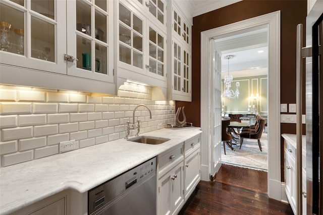 bar with dark wood-style floors, stainless steel dishwasher, a sink, crown molding, and decorative backsplash