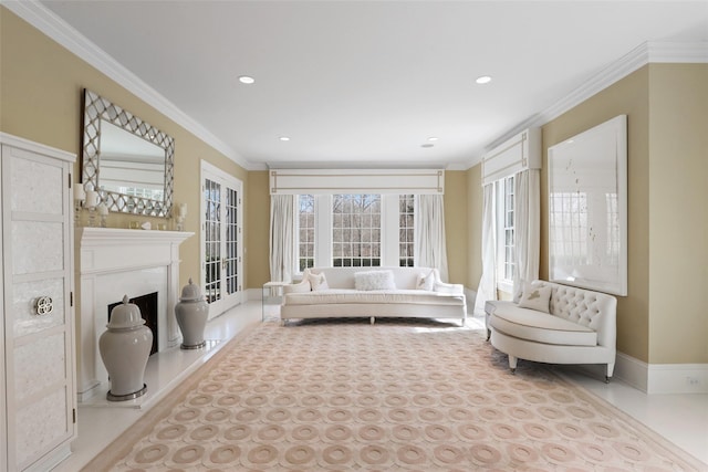living area featuring baseboards, ornamental molding, a fireplace with raised hearth, and recessed lighting