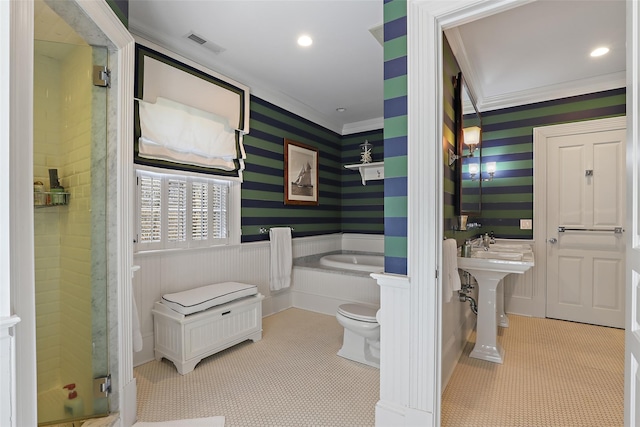 full bathroom featuring toilet, wainscoting, a stall shower, visible vents, and ornamental molding