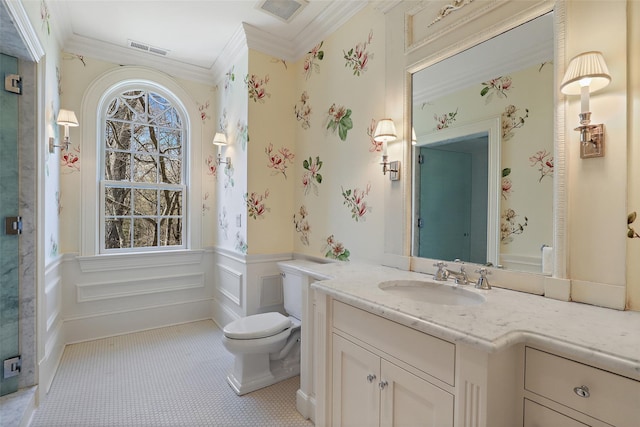bathroom featuring visible vents, crown molding, a wainscoted wall, and toilet