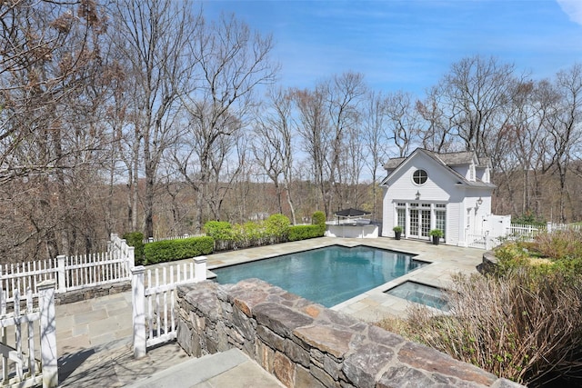 pool with an exterior structure, a patio area, french doors, an outdoor structure, and fence