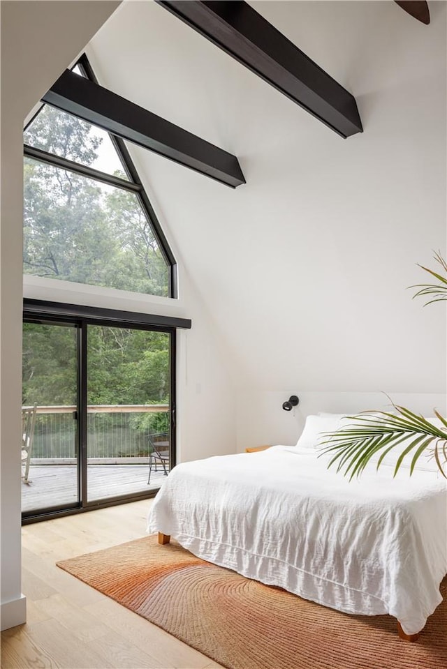 bedroom with access to outside, multiple windows, high vaulted ceiling, and light hardwood / wood-style floors