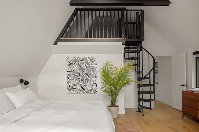 bedroom with wood-type flooring and lofted ceiling