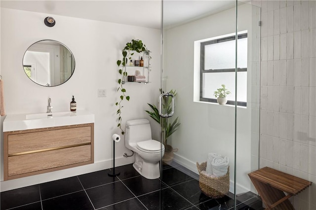 bathroom with tile patterned flooring, vanity, and toilet