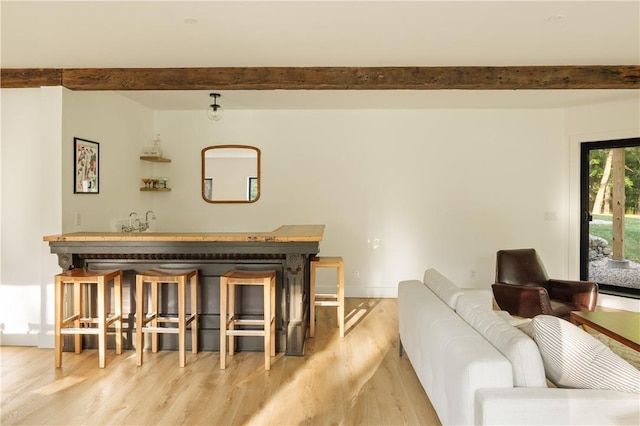 interior space featuring beamed ceiling and light wood-type flooring