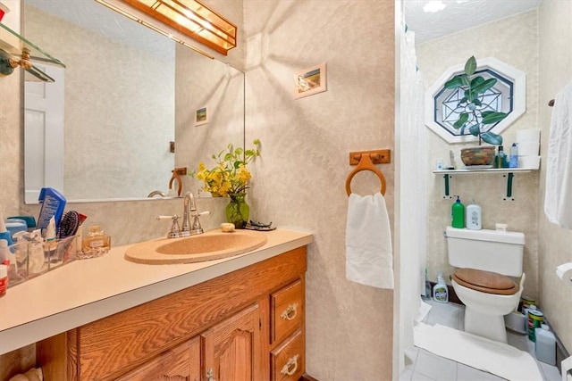 bathroom with tile patterned floors, vanity, and toilet