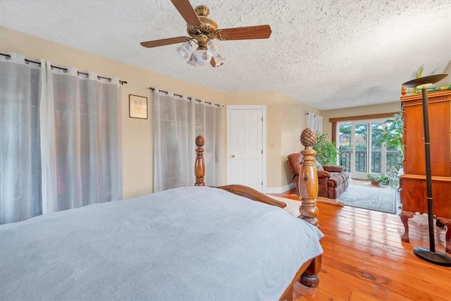 bedroom featuring ceiling fan, a textured ceiling, and hardwood / wood-style flooring