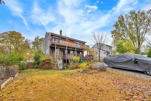 back of property featuring a wooden deck