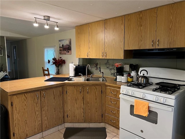 kitchen featuring white gas range, a textured ceiling, sink, exhaust hood, and light tile patterned floors